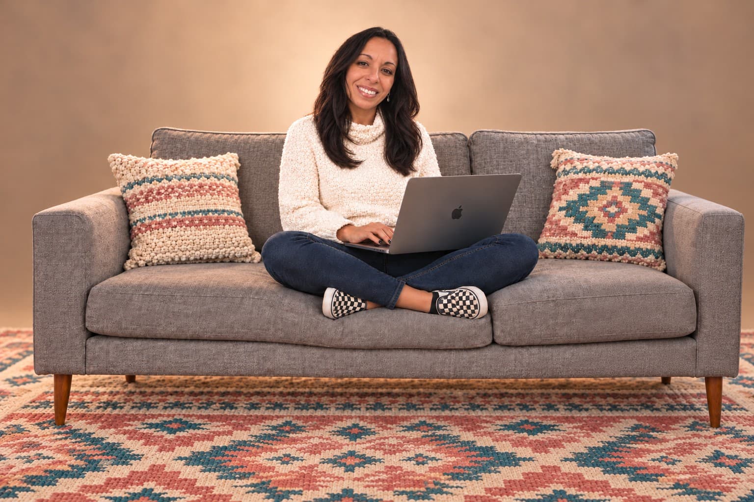 Nadin Radwan on a sofa with her laptop